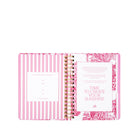 Open planner with pink and white design on a white background