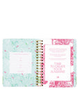 Open planner with floral design on a white background