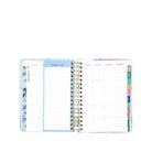 Open planner showing weekly and daily schedules with colorful tabs on a white background