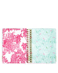 Planner with pink and white palm tree design on one cover and green and white patterned design on the other, on a white background.