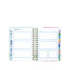 Open planner showing a monthly layout with colorful tabs on a white background