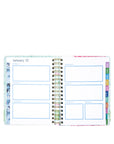 Open planner showing a monthly layout with colorful tabs on a white background