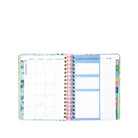 Open planner showing monthly and weekly layout with colorful tabs on a white background