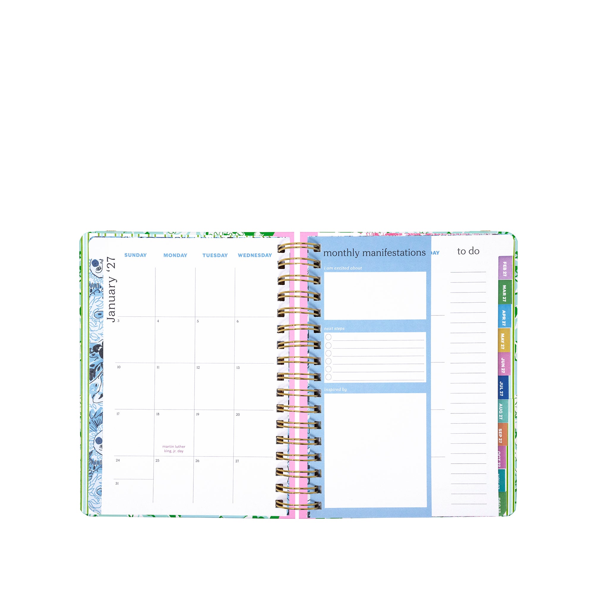 Open planner showing monthly and weekly layout with colorful tabs on a white background