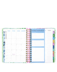 Open planner showing monthly and weekly layout with colorful tabs on a white background