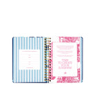 Open planner with decorative cover and interior pages on a white background