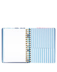 Open notebook with spiral binding on a white background