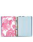 planner with pink floral design on one side and plain pages on the other, on a white background.
