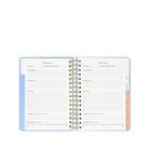 Open planner with spiral binding on a white background