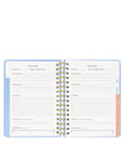 Open planner with spiral binding on a white background