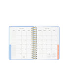 Open planner with monthly calendar layout on a white background