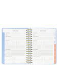 Open planner with vacation planner section on a white background