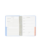 Open planner with weekly schedule and notes section on a white background