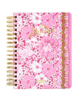 Pink floral planner with gold accents on a white background