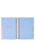 Open planner with colorful tabs on a white background