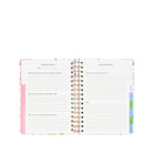 Spiral-bound planner with colorful tabs on a white background