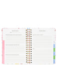 Spiral-bound planner with colorful tabs on a white background