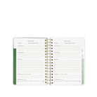 Open planner with goal tracking pages on a white background
