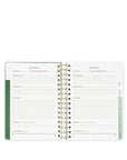 Open planner with goal tracking pages on a white background