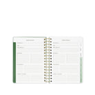Open planner with vacation planner section on a white background