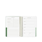 Wiro-bound planner with weekly and monthly layout on a white background