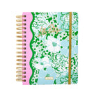 Floral patterned planner with gold spiral binding on a white background