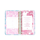 Open planner with floral design on cover and interior pages.