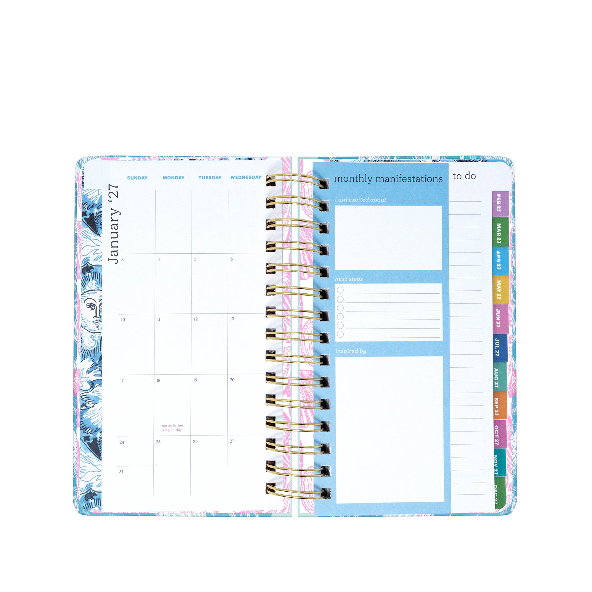 Planner with monthly layout and colorful tabs on a white background