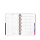 Open planner with monthly calendar layout on a white background