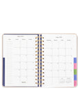 Open planner with monthly calendar layout on a white background