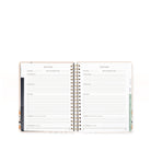 Open planner with goal tracking pages on a white background