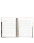 Open planner with goal tracking pages on a white background