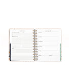 Open planner showing weekly schedule layout on white background