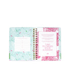 Open planner with floral design on a white background