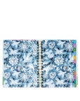 Open planner with blue floral design and colorful tabs on a white background