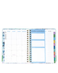 Planner with monthly layout and colorful tabs on a white background