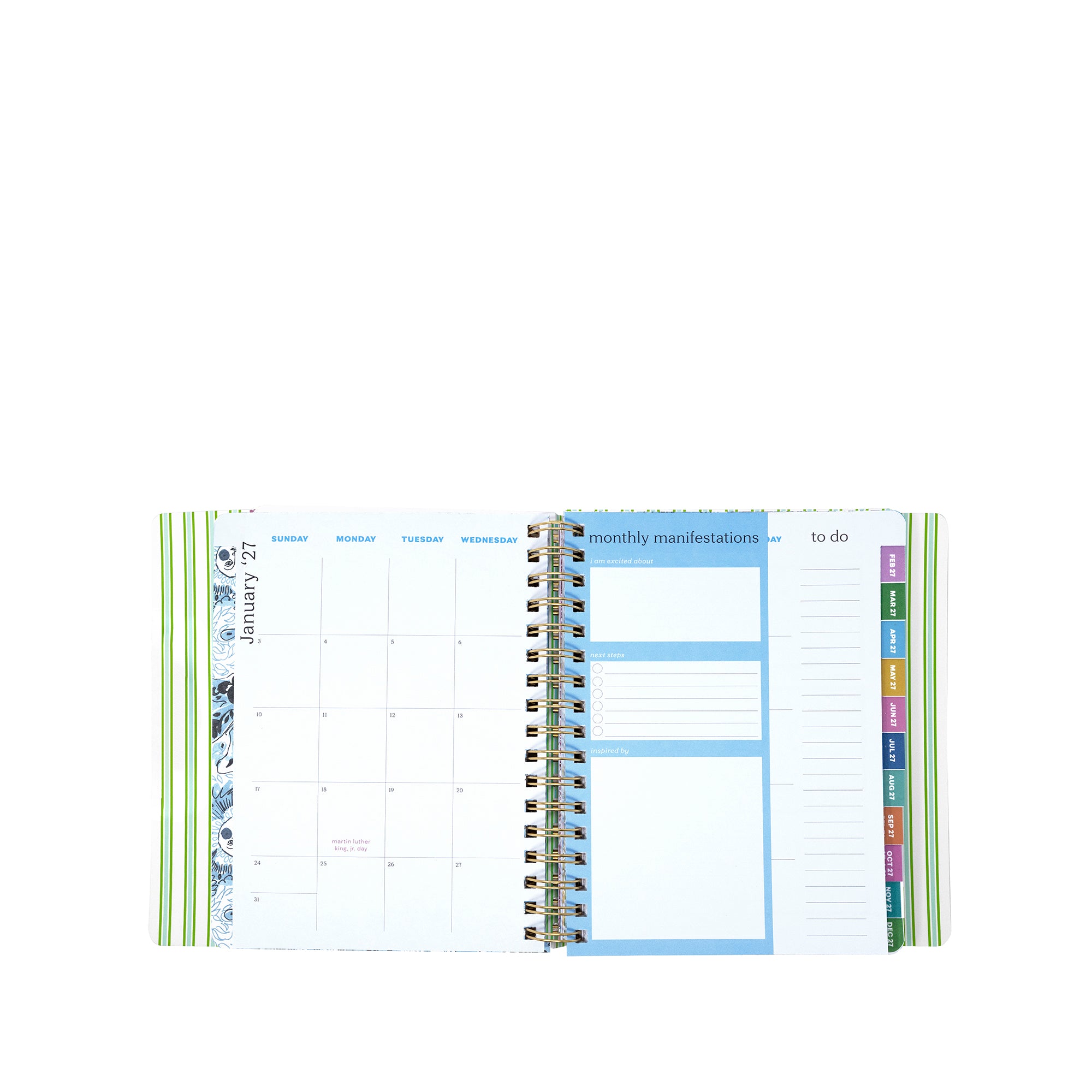Open planner showing monthly layout with colorful tabs on a white background