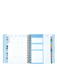 Spiral-bound planner with various sections on a white background