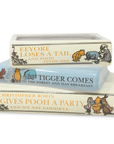 Three books stacked on top of each other with Winnie the Pooh illustrations and text.