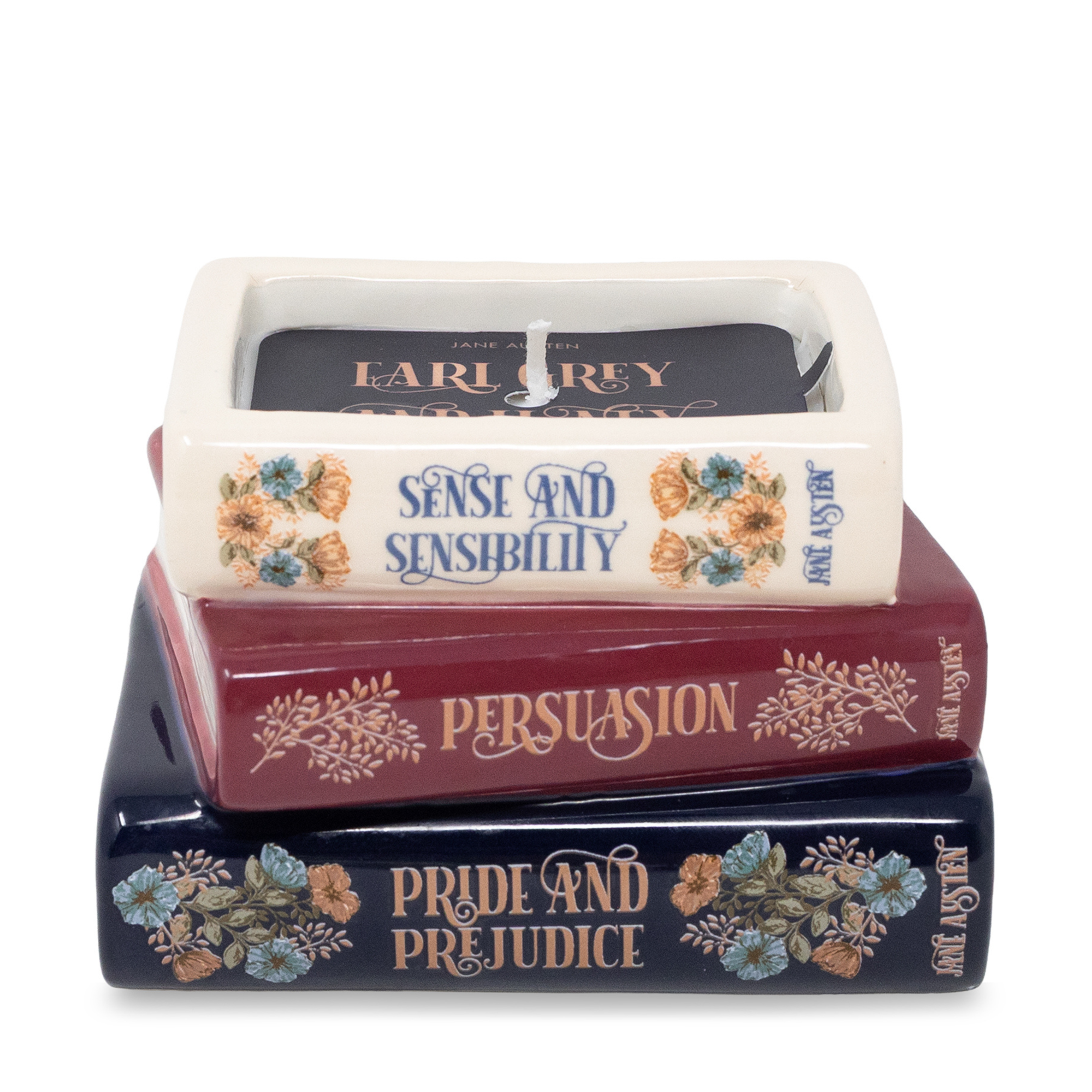 Stack of books with candles labeled &#39;Pride and Prejudice&#39;, &#39;Persuasion&#39;, and &#39;Sense and Sensibility&#39; on a white background.