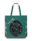 Green tote bag with 'There is No Place Like Home' quote and star designs on a white background
