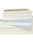 Stack of ceramic pots with blue and beige stripes on a white background