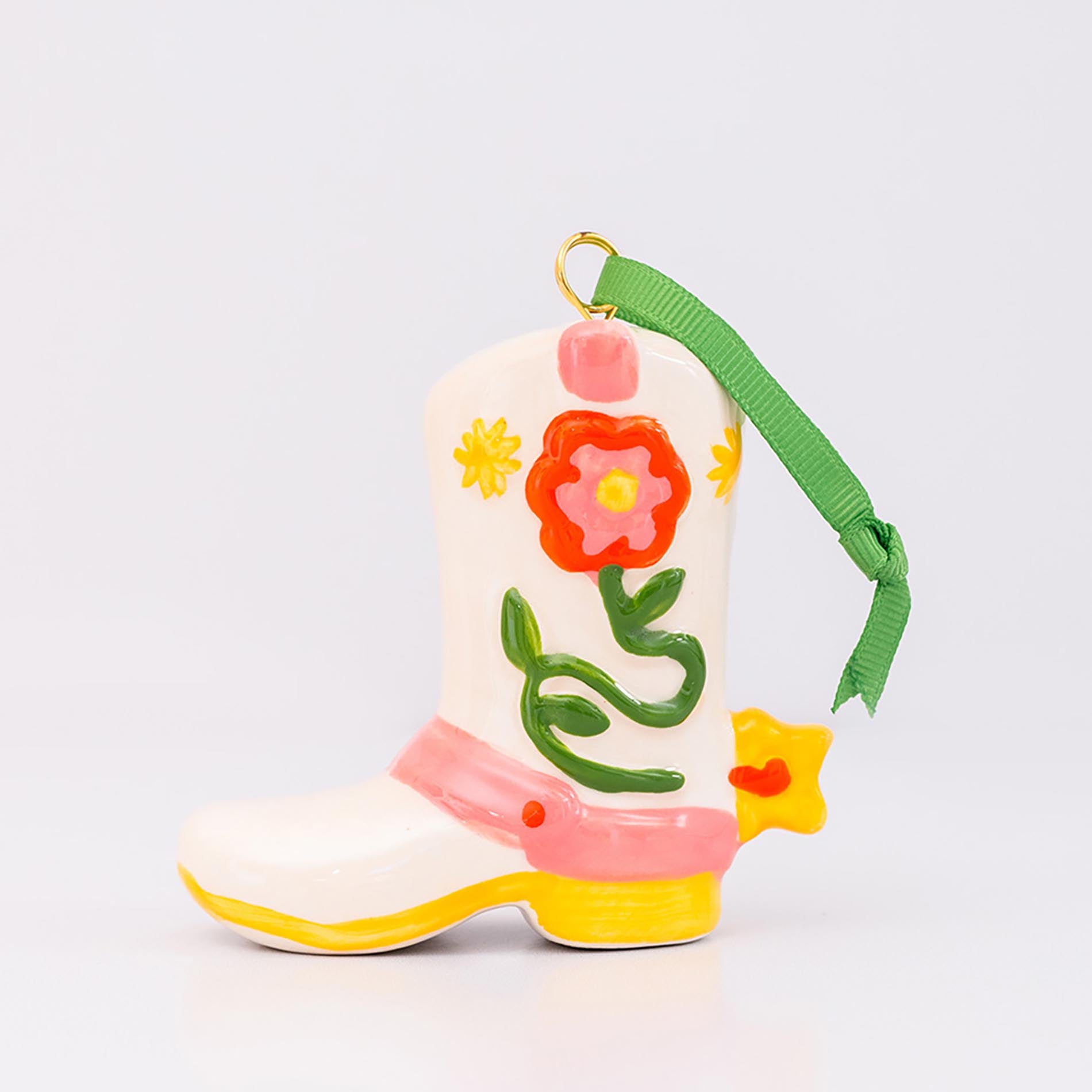 Decorative boot ornament with floral design on a white background