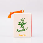 Backview of ornament with 'THERE'S A REALLY GOOD PLOT TWIST IN HERE' and an orange hanger on a white background