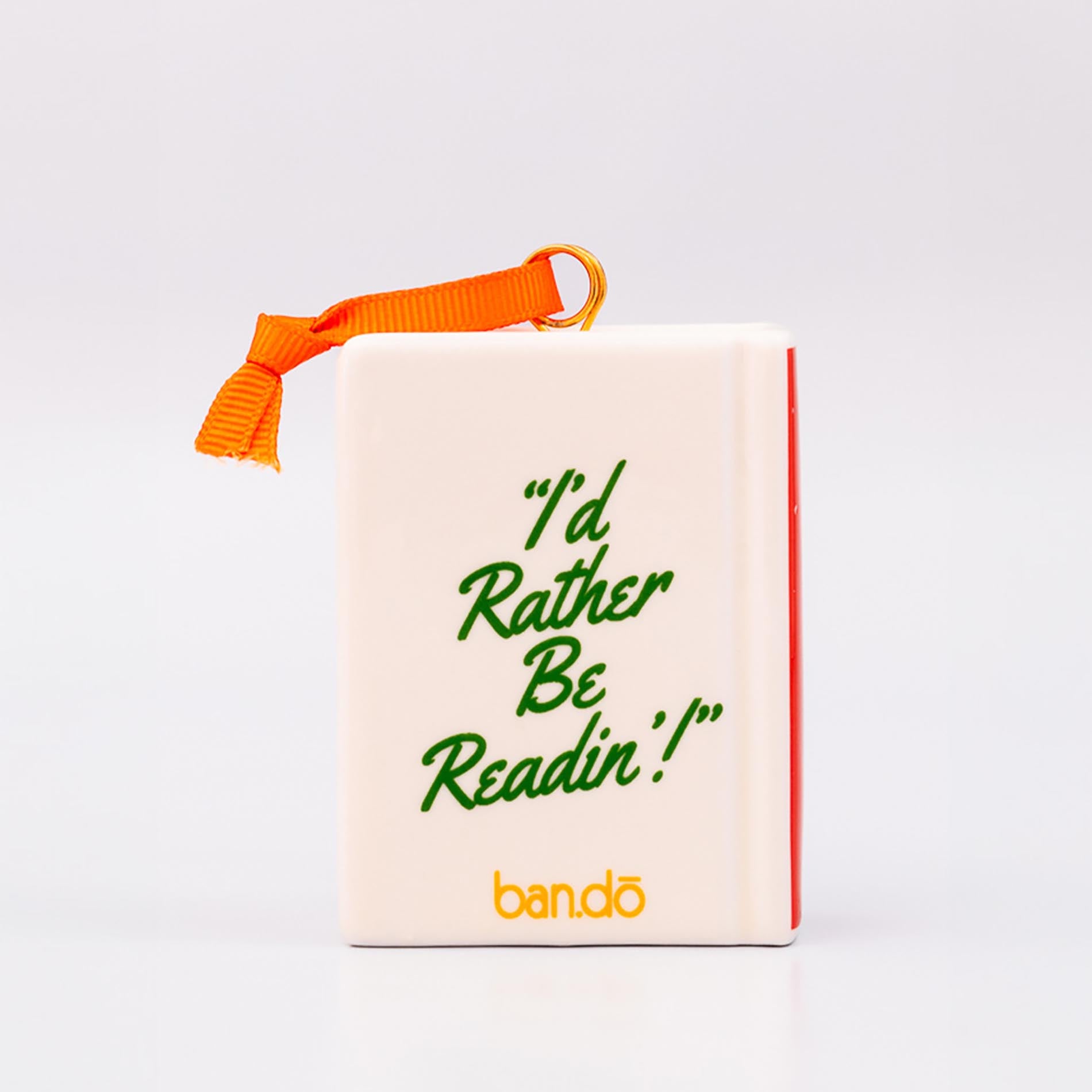 Backview of ornament with 'THERE'S A REALLY GOOD PLOT TWIST IN HERE' and an orange hanger on a white background