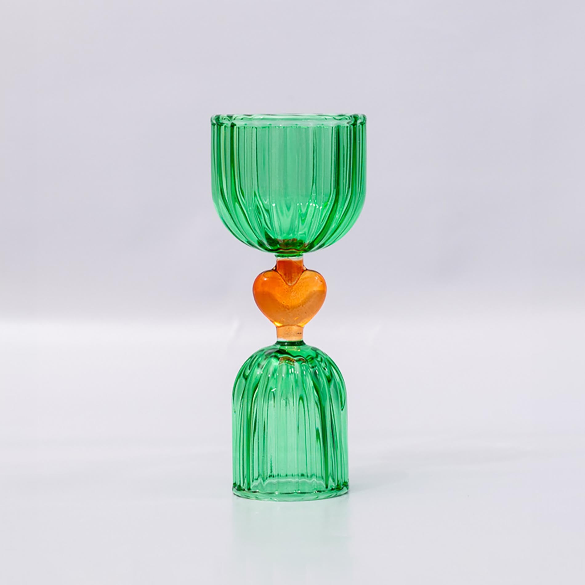 Green glass shot glass with yellow heart center
