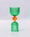 Green glass shot glass with yellow heart center