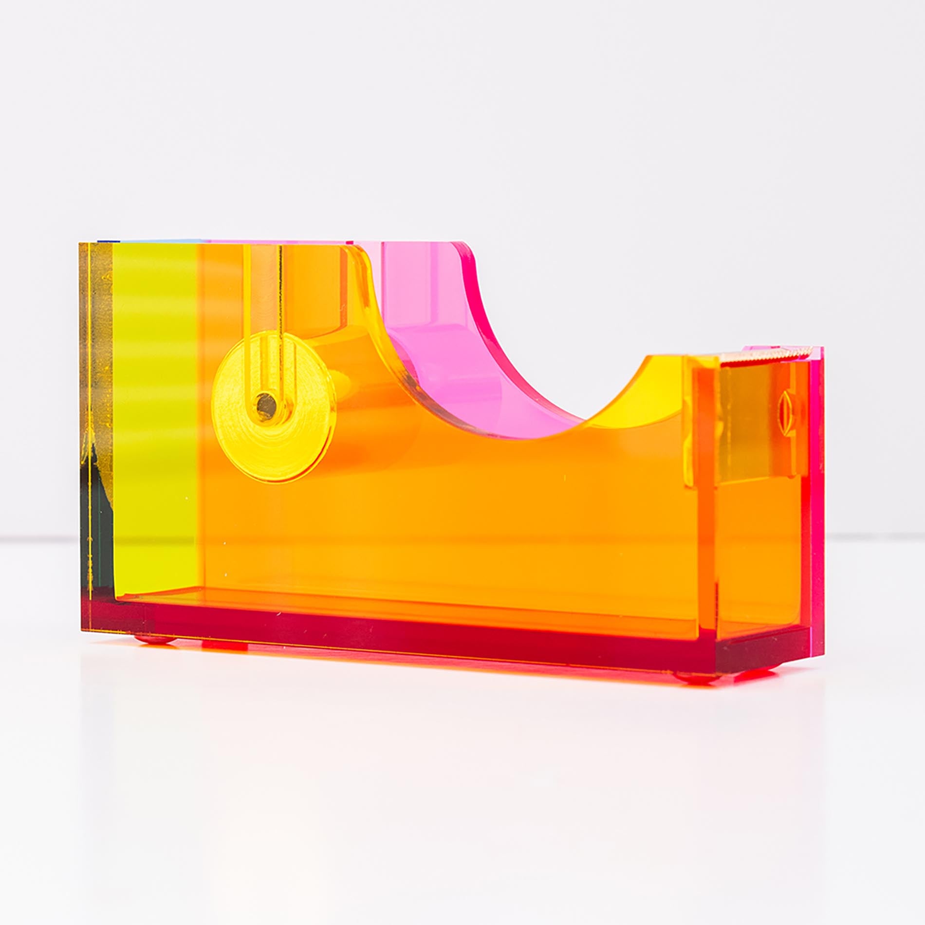 Colorful tape dispenser with yellow, pink, and red colors on a white background