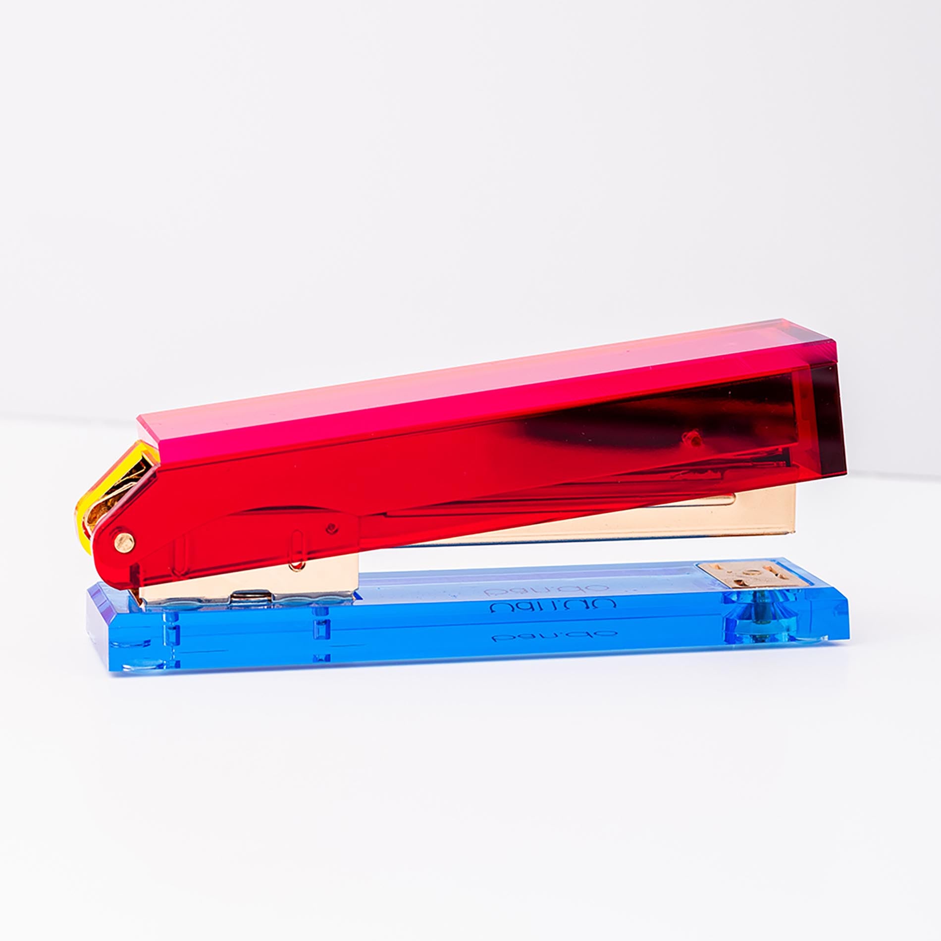 Colorful stapler with red and blue components on a white background