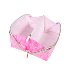 Pink cosmetic bag with floral pattern on a white background